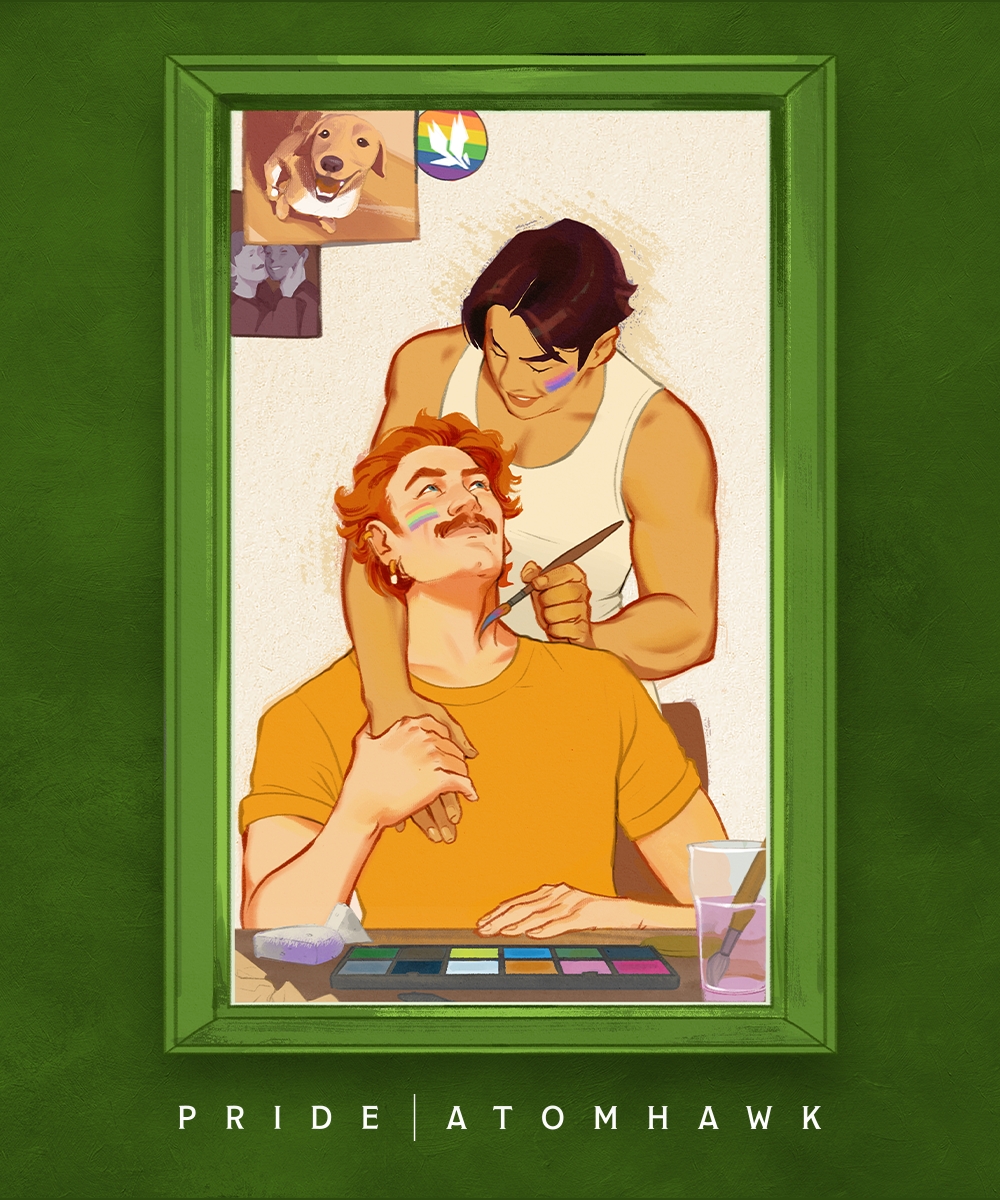 Two men smile warmly as one applies make-up to the other’s face. Framed in green, with a photo of a dog and a rainbow pride sticker behind them, their queer joy shines. Text below reads PRIDE 2026 | ATOMHAWK.